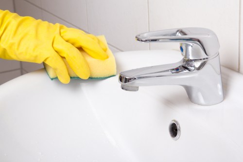 Technician treating sofa stains during sofa cleaning service